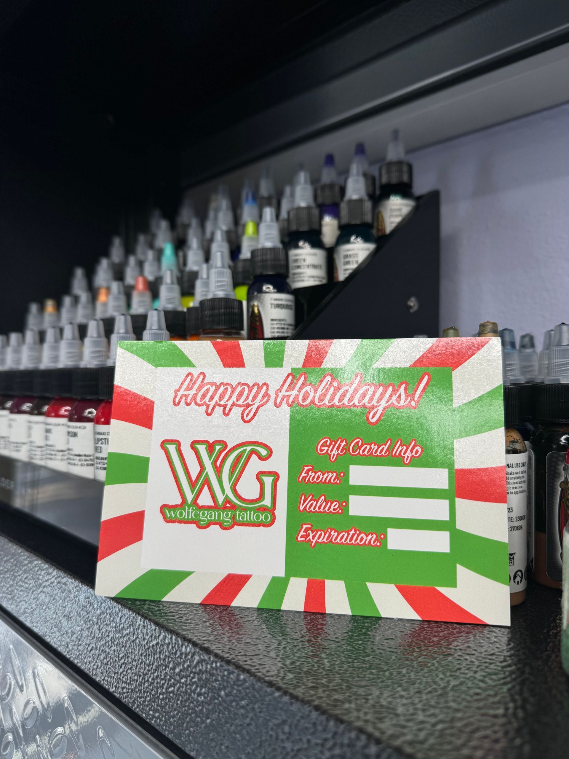 A woman is getting a tattoo on another woman 's arm.