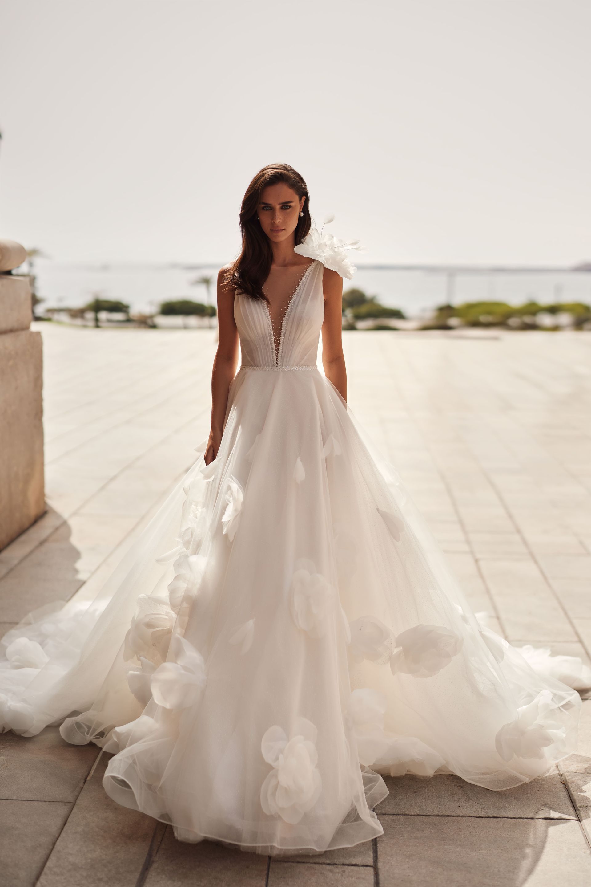 Eine Frau in einem weißen Brautkleid steht auf einem Bürgersteig.