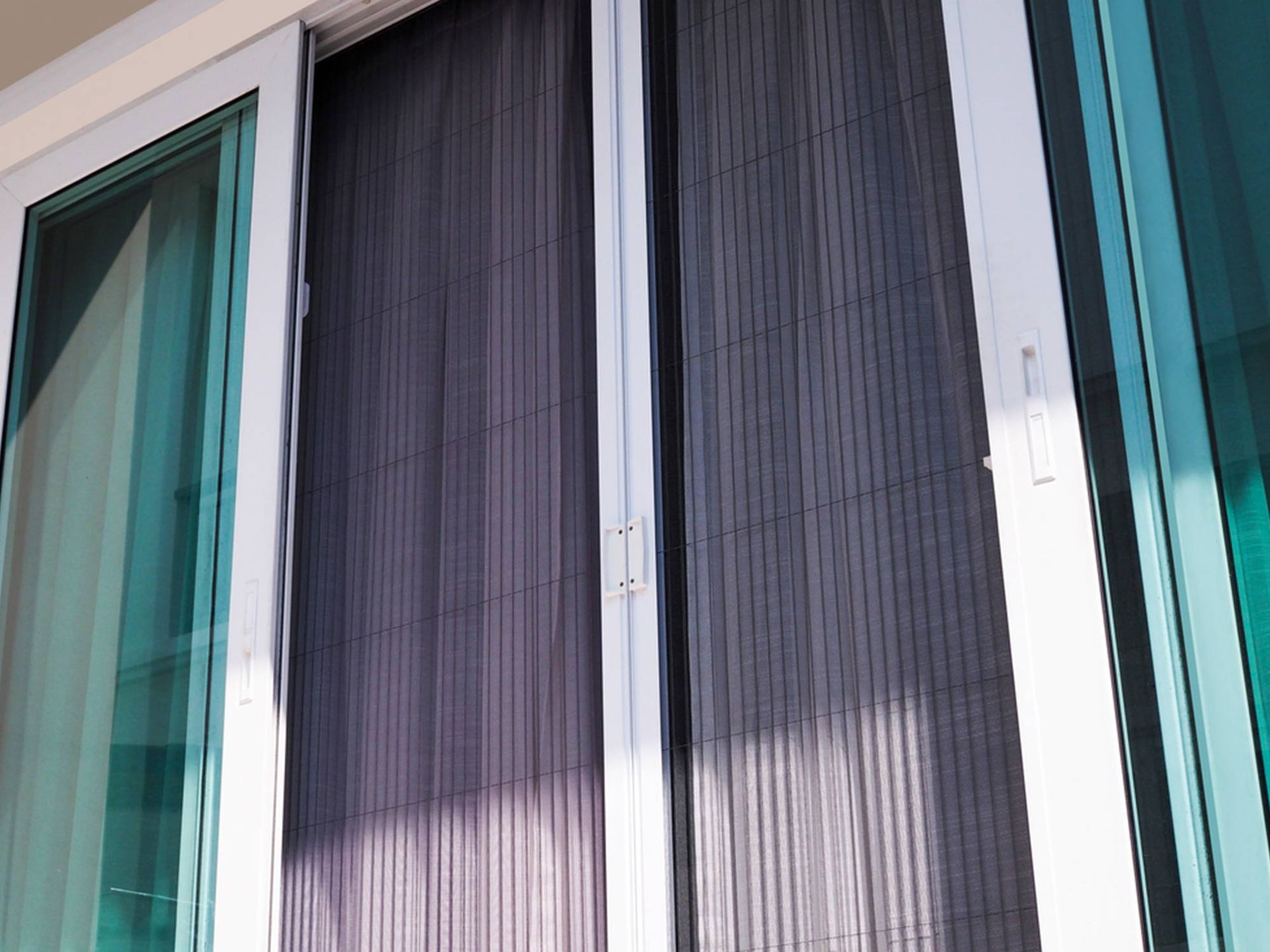 A Close Up Of A Sliding Glass Door With A Screen On It — Readycut Screens & Doors in Humpty Doo, NT