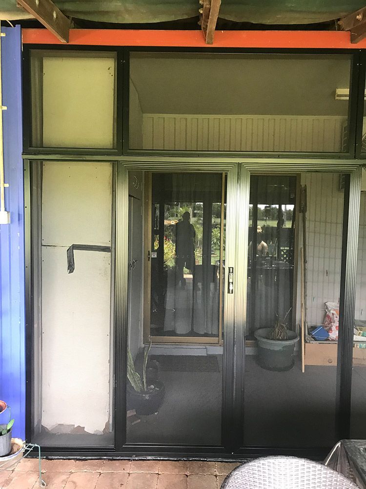 A Sliding Glass Door With A Screen On It Is Open To A Patio — Readycut Screens & Doors in Winnellie, NT