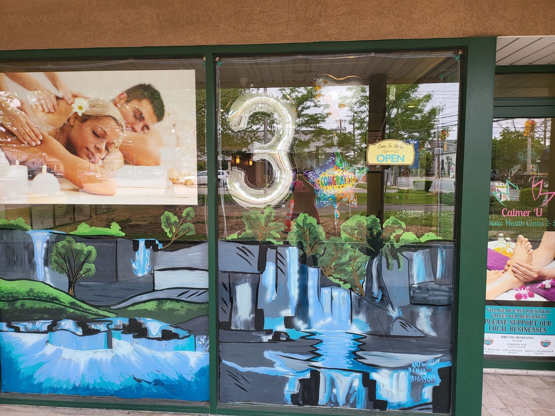 Spa storefront with a hand-painted waterfall scene and a 
