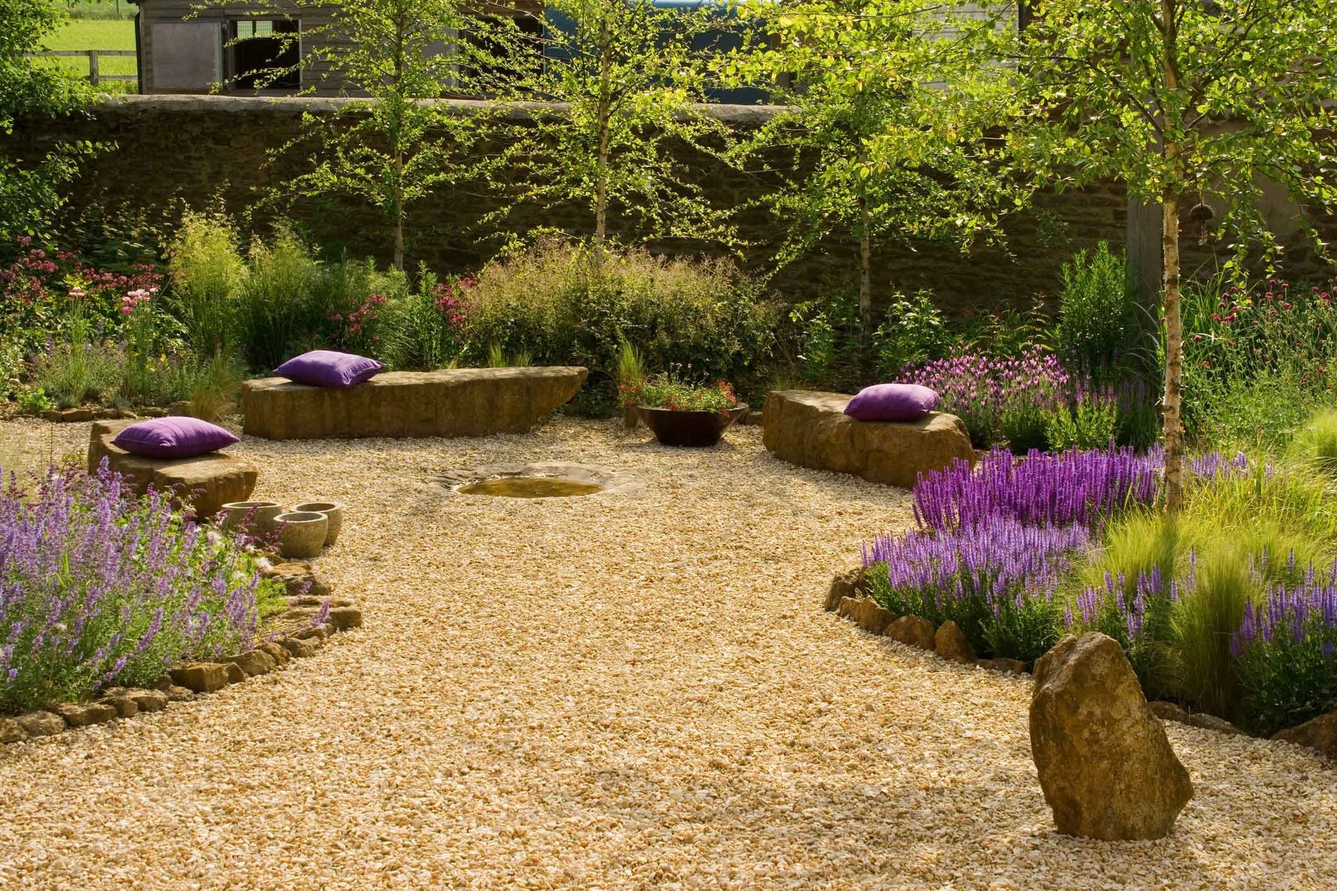 A garden with purple flowers and purple pillows A garden with purple flowers and purple pillows