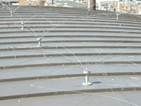 A close up of a row of stairs with a roof in the background.