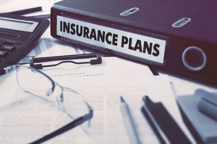 insurance plans ring binder on office