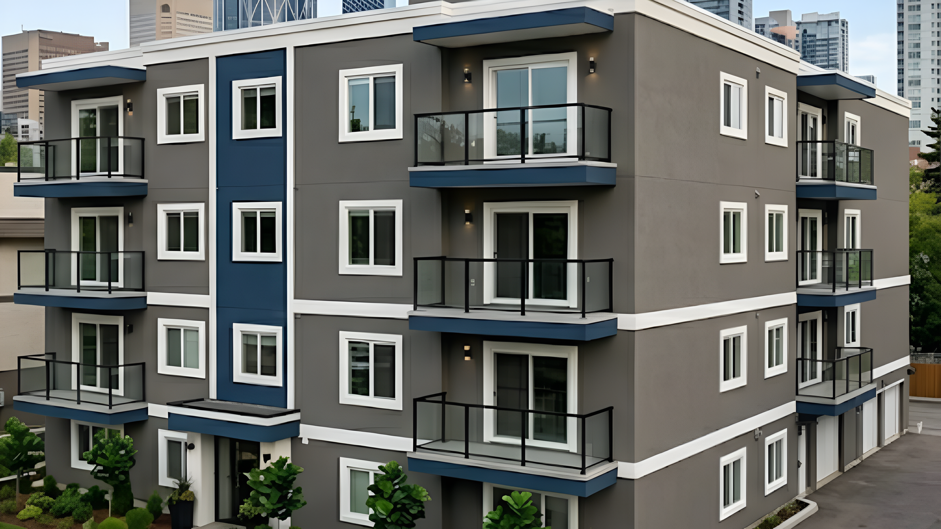 Modern gray-and-blue apartment building with balconies and large windows in an urban setting