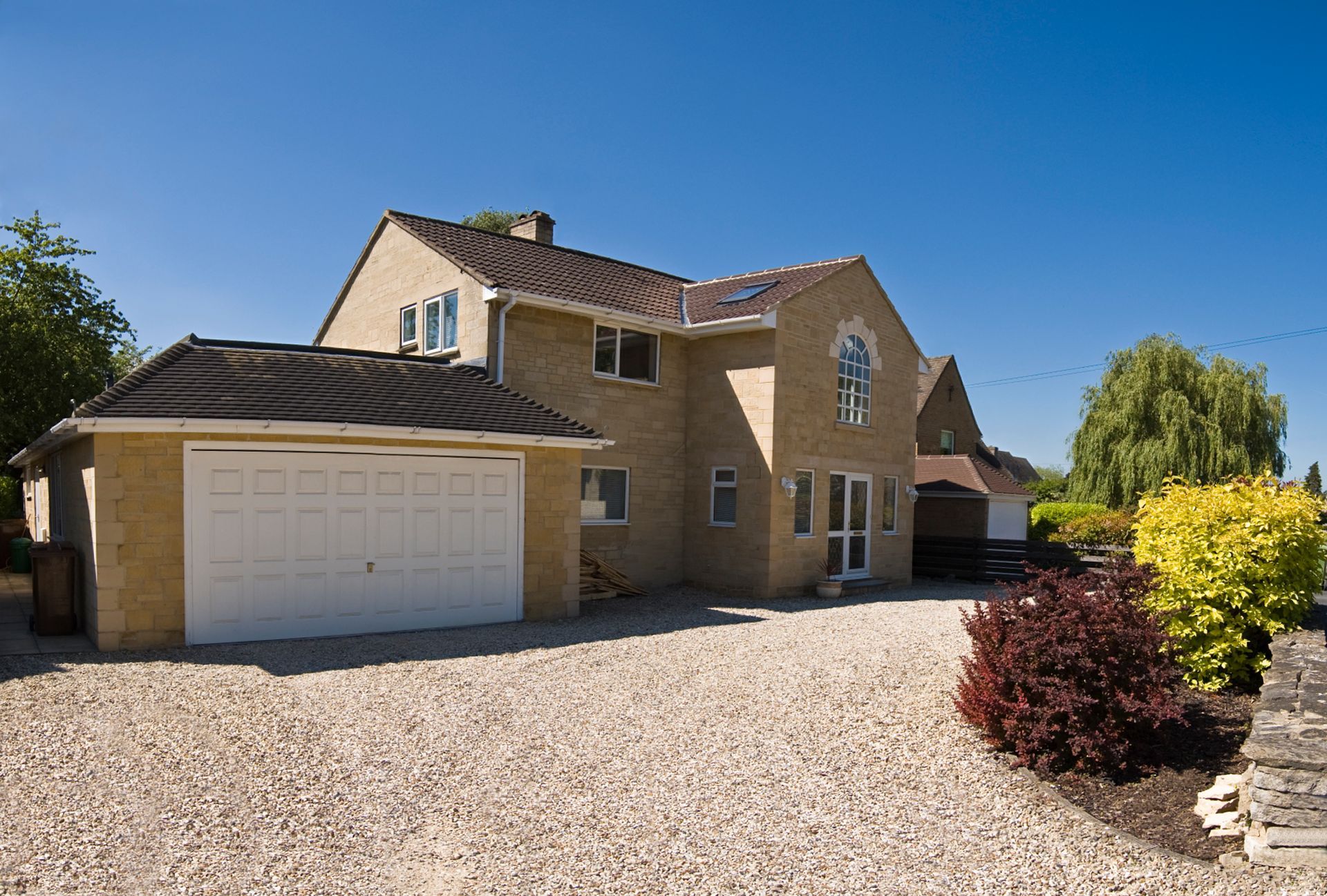 A large brick house with a white garage door