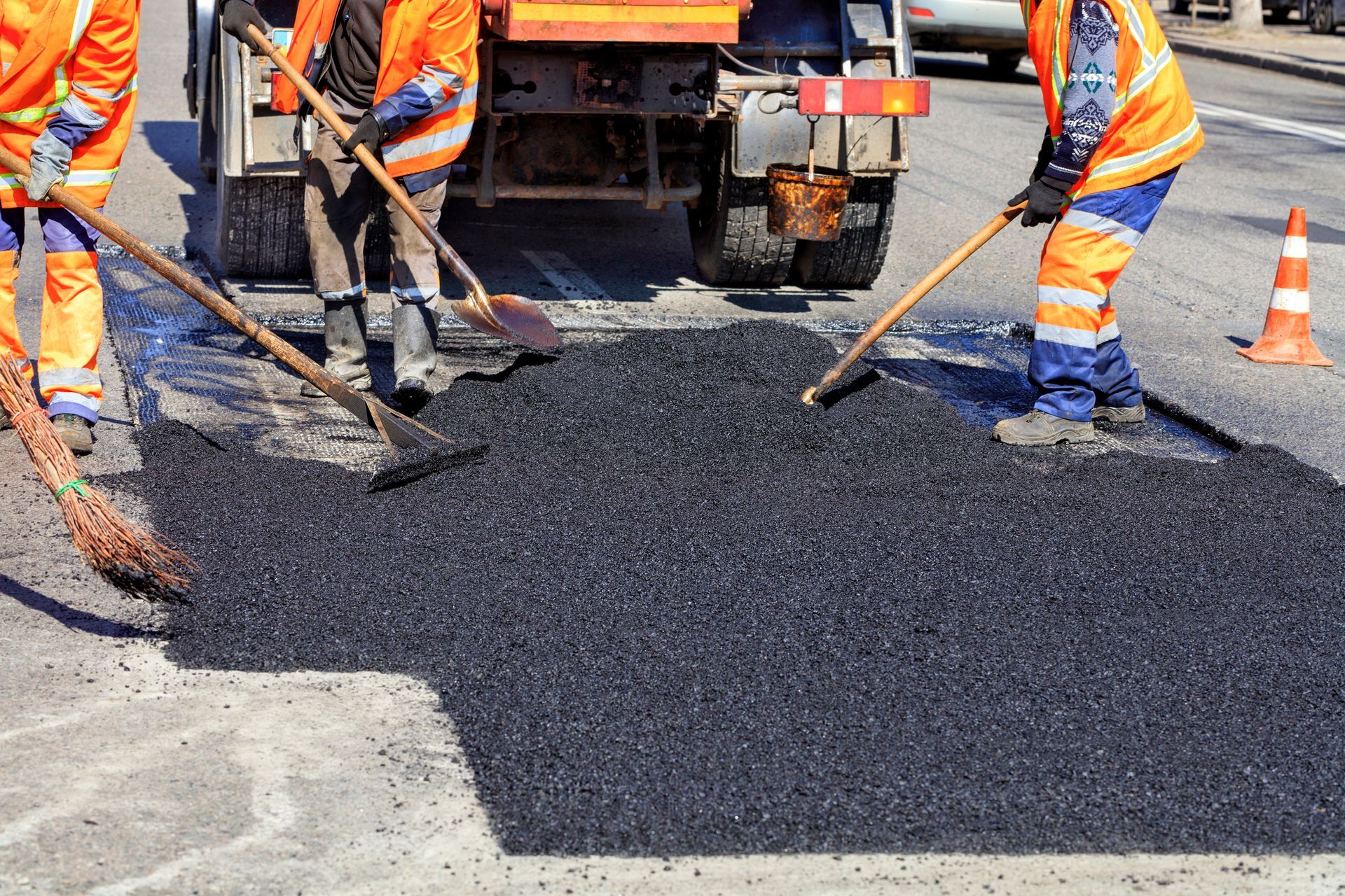 Group of construction workers are working on a road.