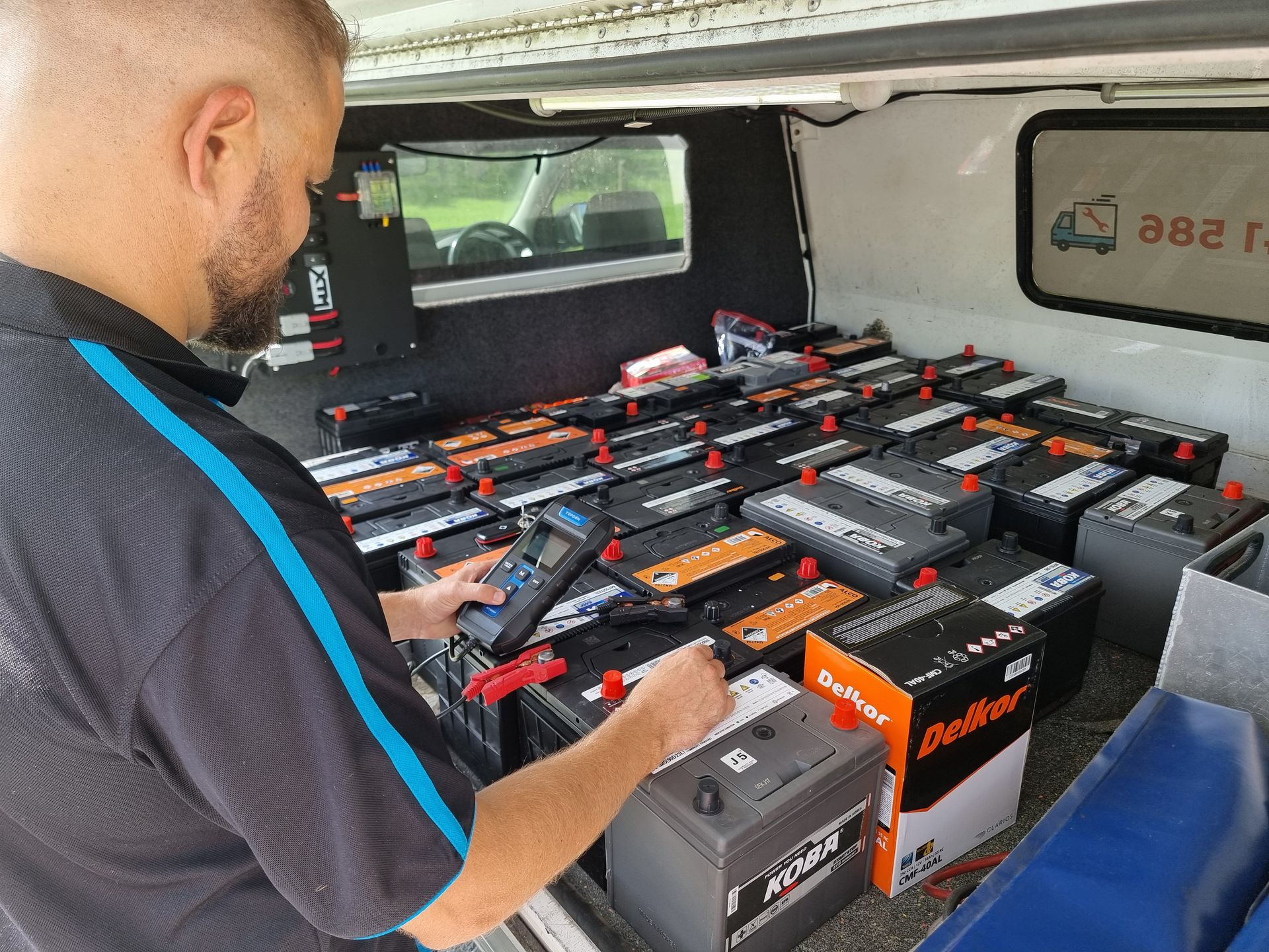 Man Testing Car Batteries in a Van. Many Batteries — ASAP Batteries & Breakdowns in Burleigh Heads, QLD