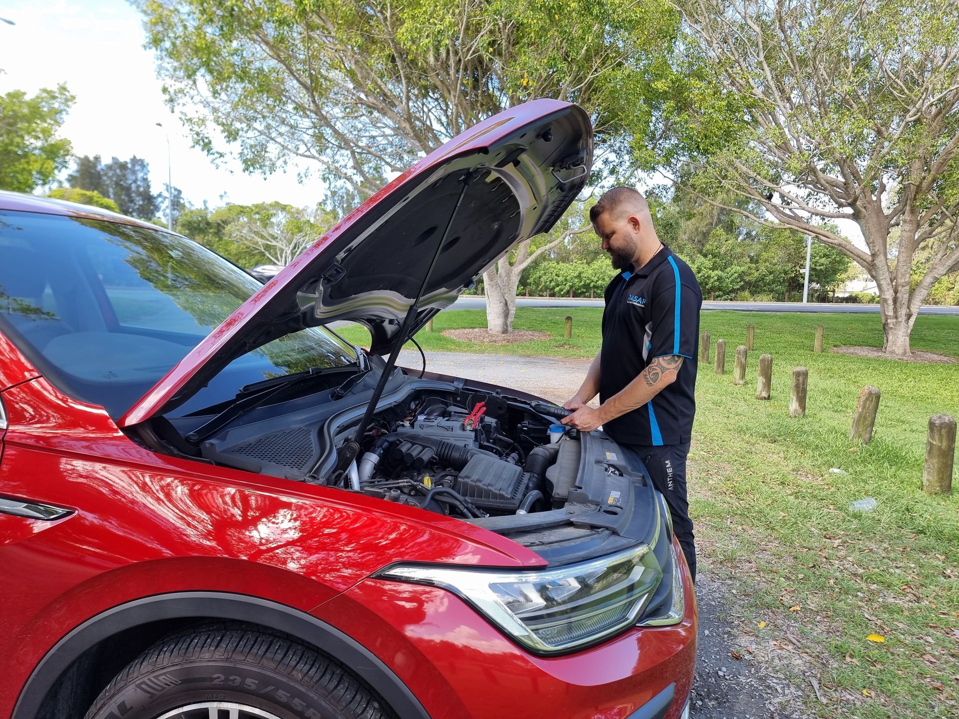 Person in a Black Shirt Checks the Engine — ASAP Batteries & Breakdowns in Burleigh Heads, QLD