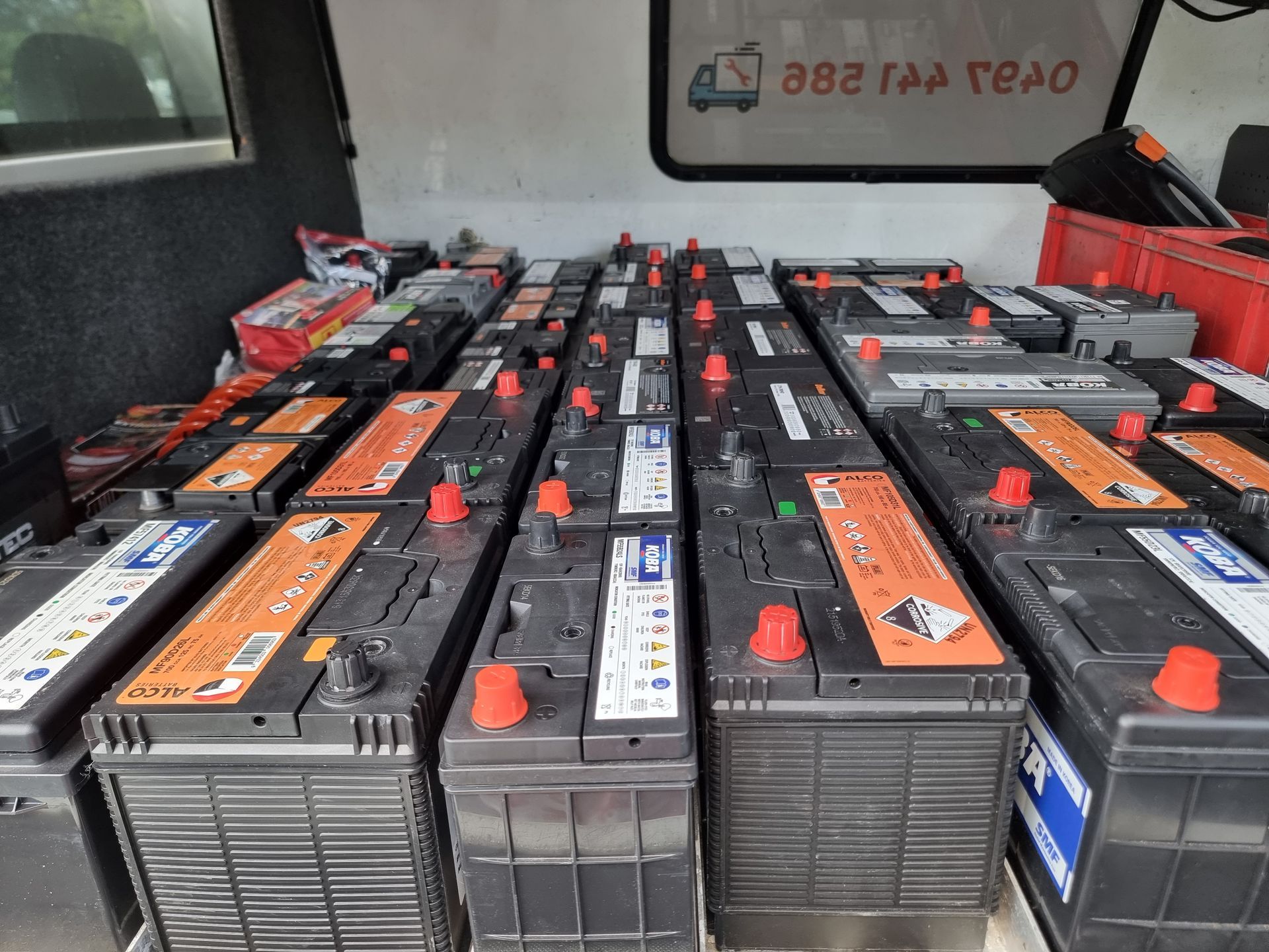A Collection of Rectangular Black Car Batteries With Red Terminals Inside a Vehicle — ASAP Batteries & Breakdowns in Burleigh Heads, QLD