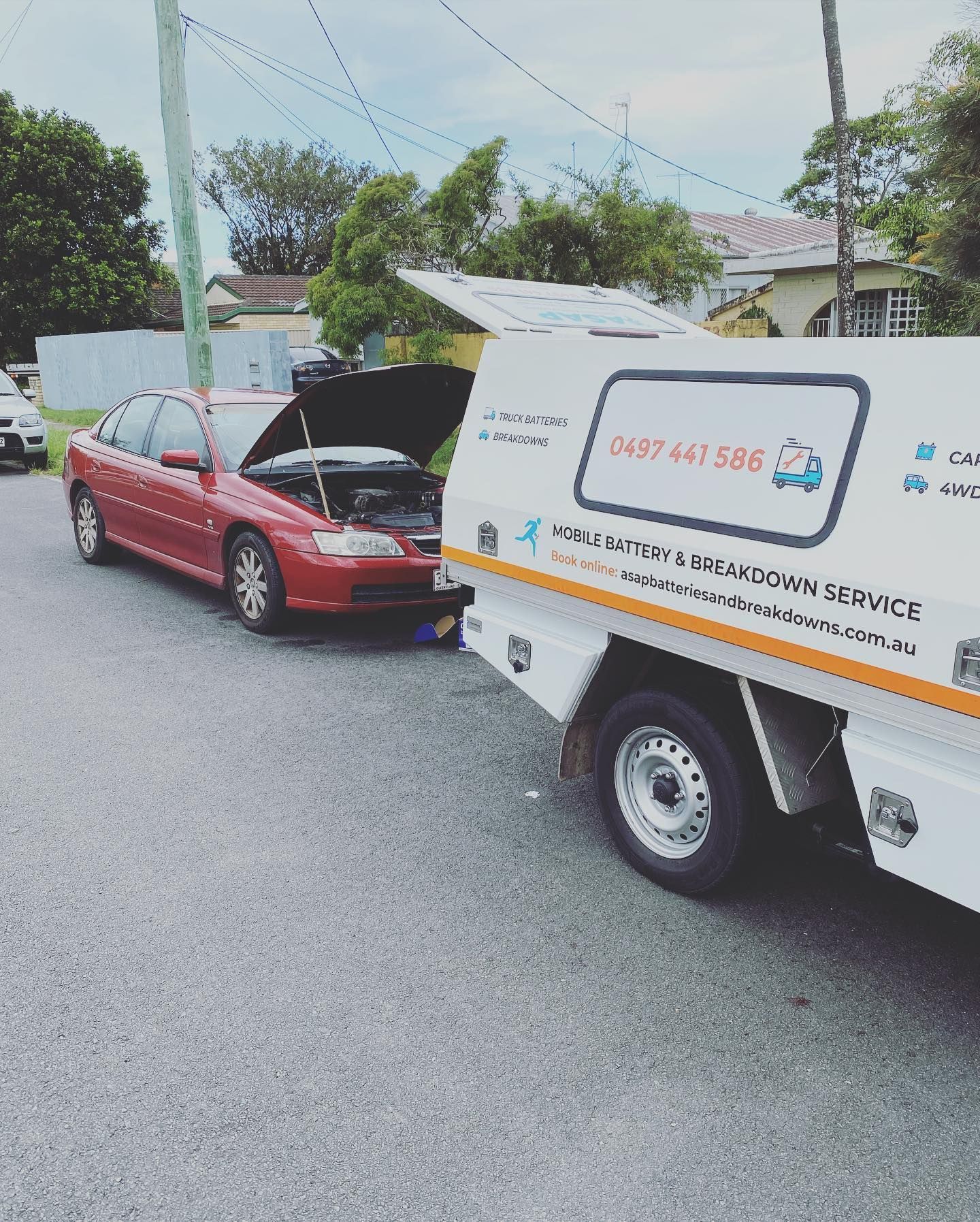 Red Car Being Assist by a White Service Truck — ASAP Batteries & Breakdowns in Burleigh Heads, QLD