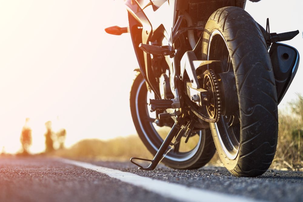 Motorcycle Parked on a Road, Tire in Focus — ASAP Batteries & Breakdowns in Burleigh Heads, QLD