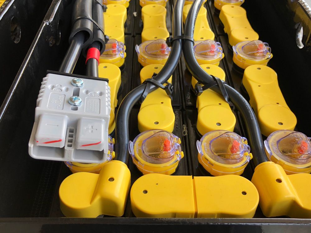 Close-up of a Black Battery Case With Yellow Battery Terminals and Electrical Wiring Connected — ASAP Batteries & Breakdowns in Burleigh Heads, QLD