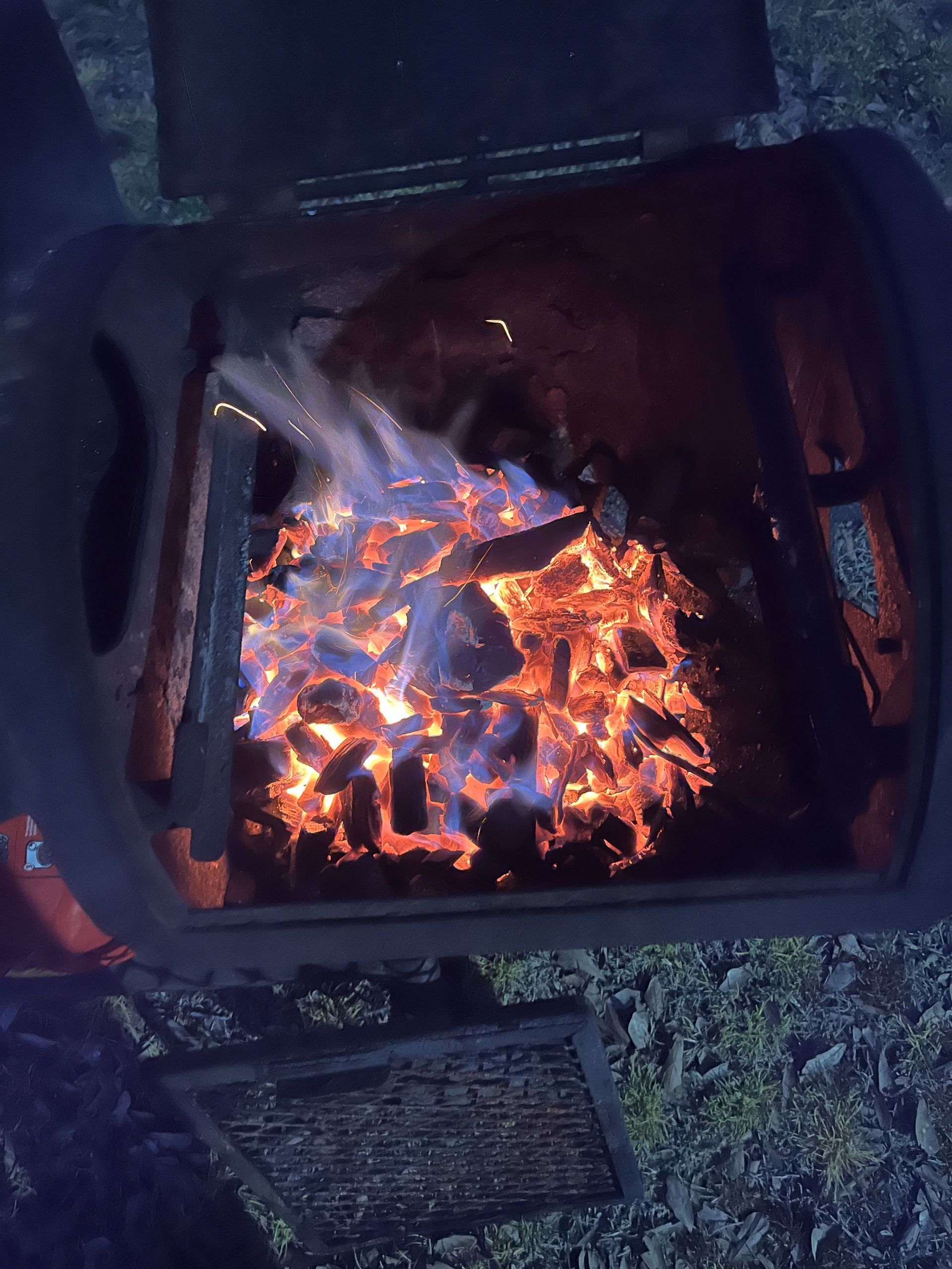 A fire is being lit in a trash can