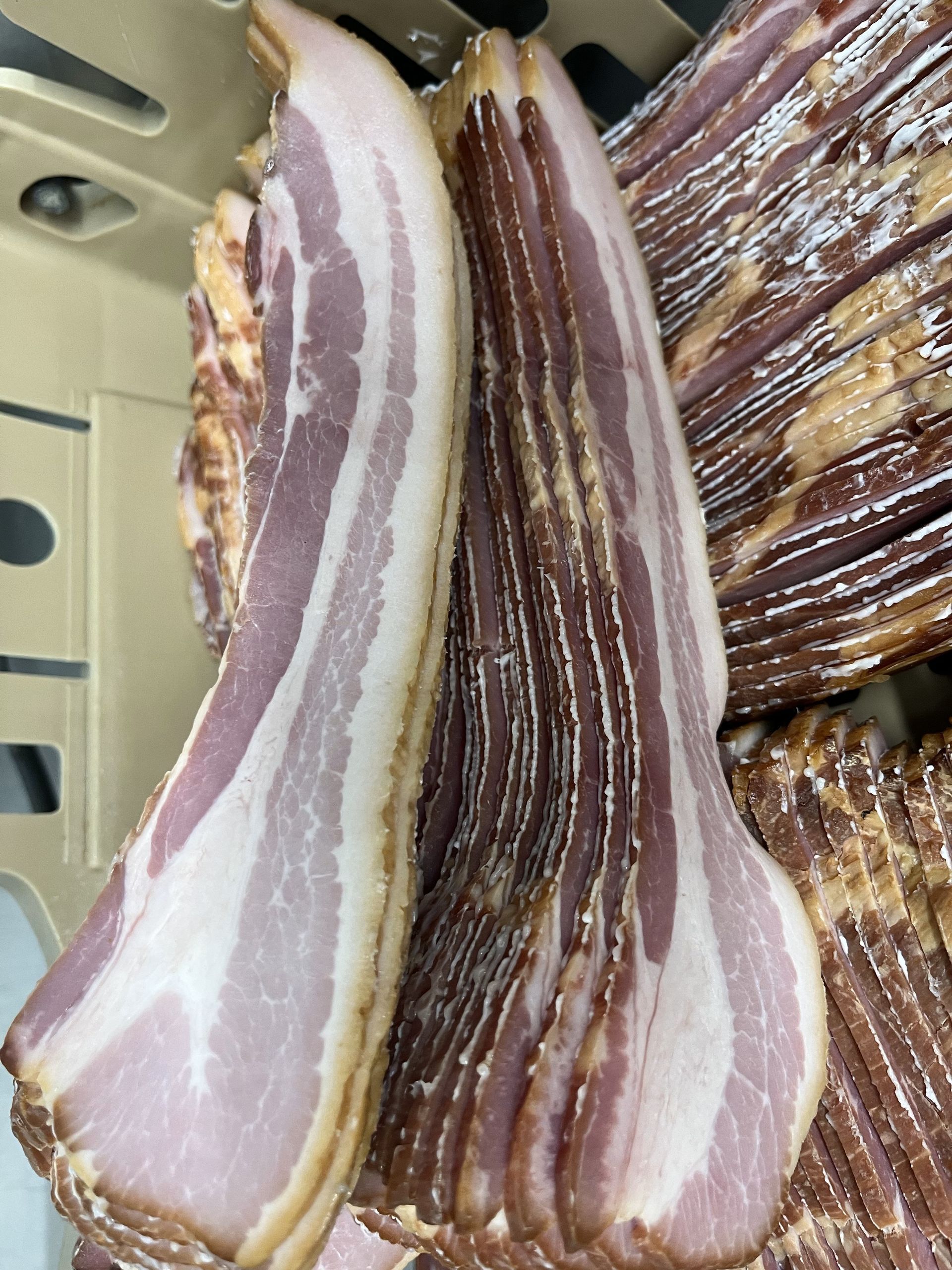 A pile of bacon is sitting on top of each other on a table.