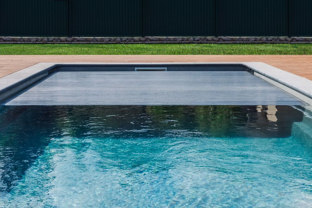 Pool With a Retractable Cover. Water Reflects Light — Donna's Pool & Spa Centre In Port