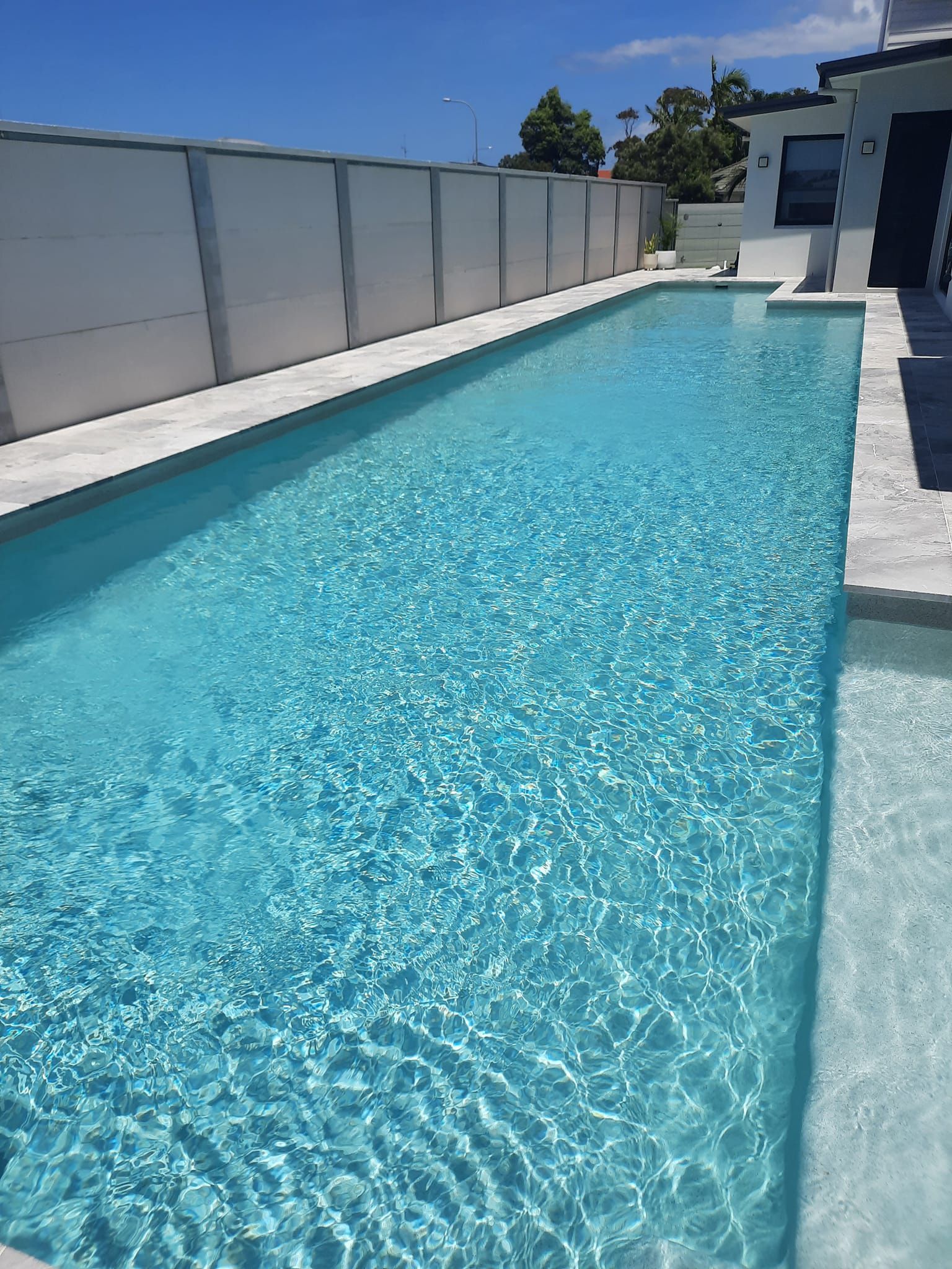 Swimming Pool With Blue Tiles and a Metal Ladder — Donna's Pool & Spa Centre In Port 