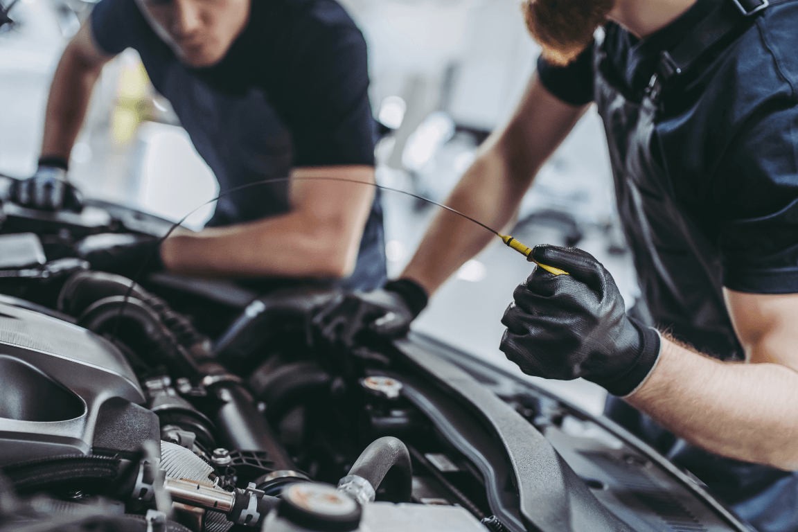 two mechanics doing an on-site auto maintenance service
