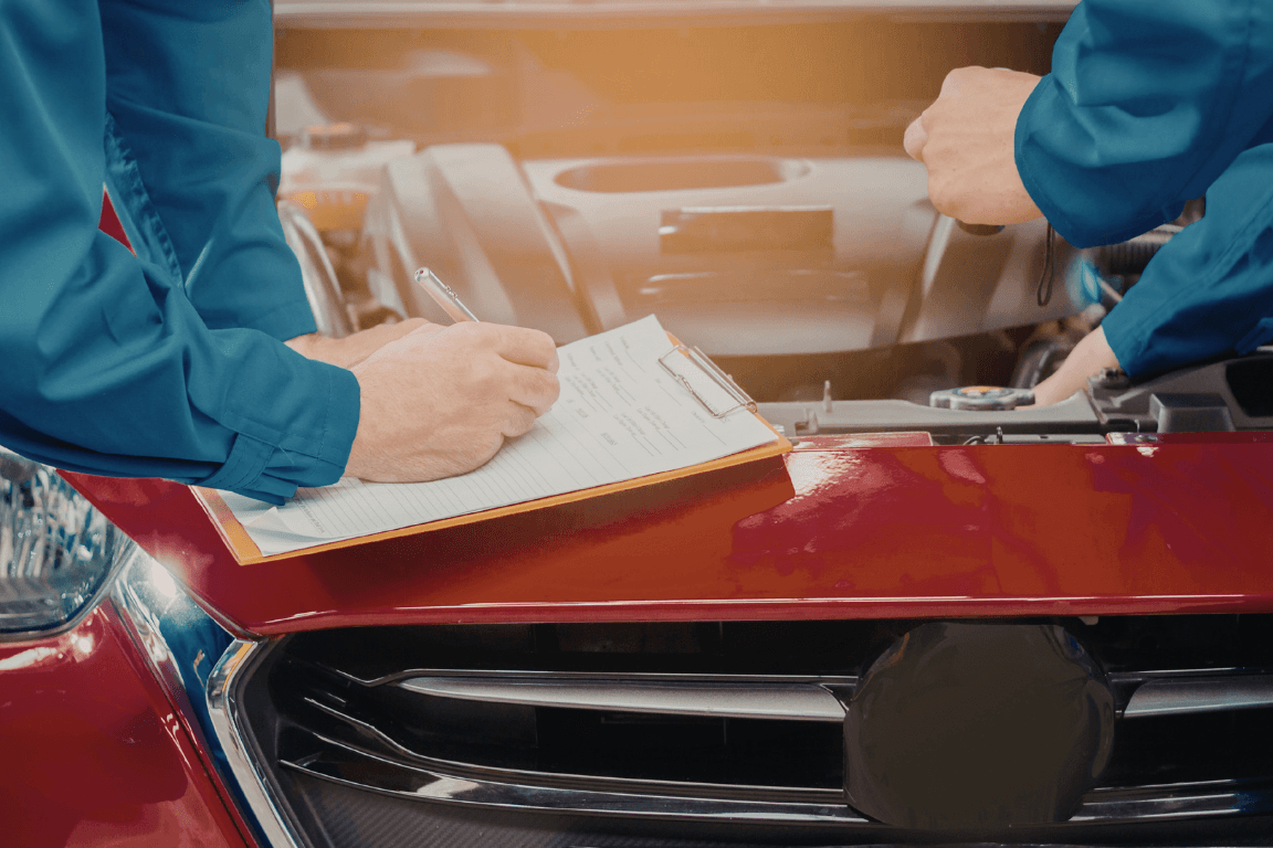 two mechanics doing a pre-purchase vehicle inspection