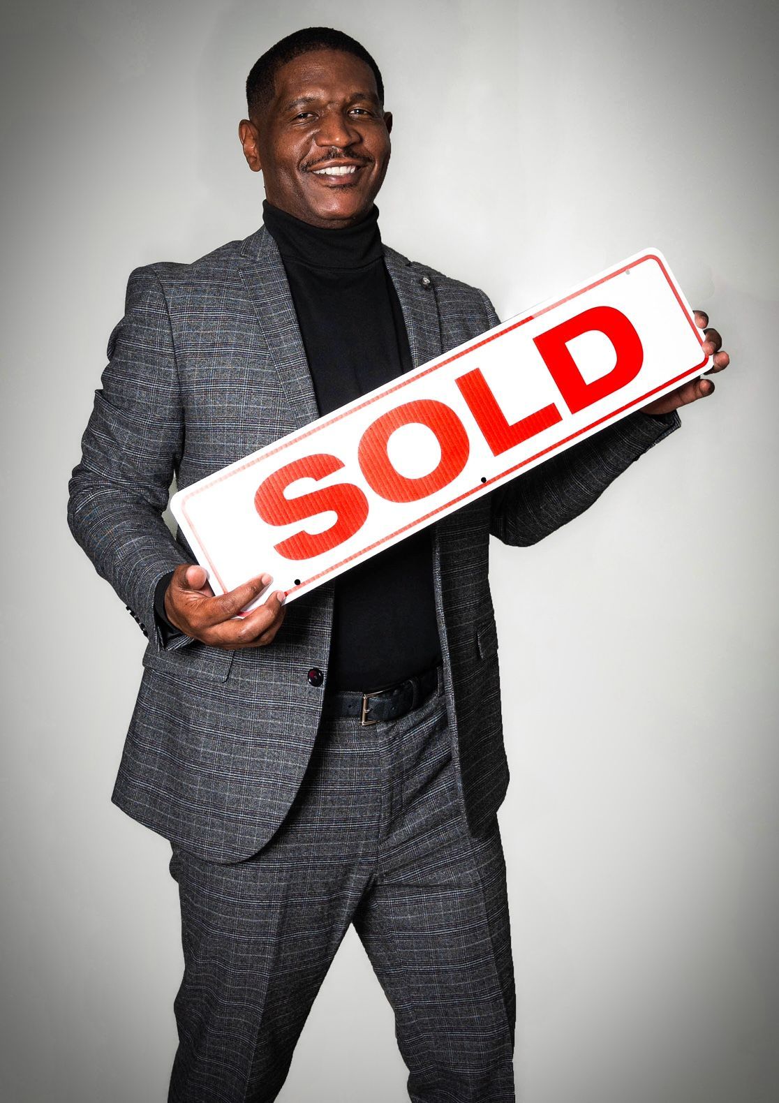 Man in suit holding a 