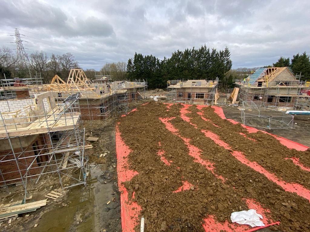 A construction site with a lot of dirt and scaffolding.