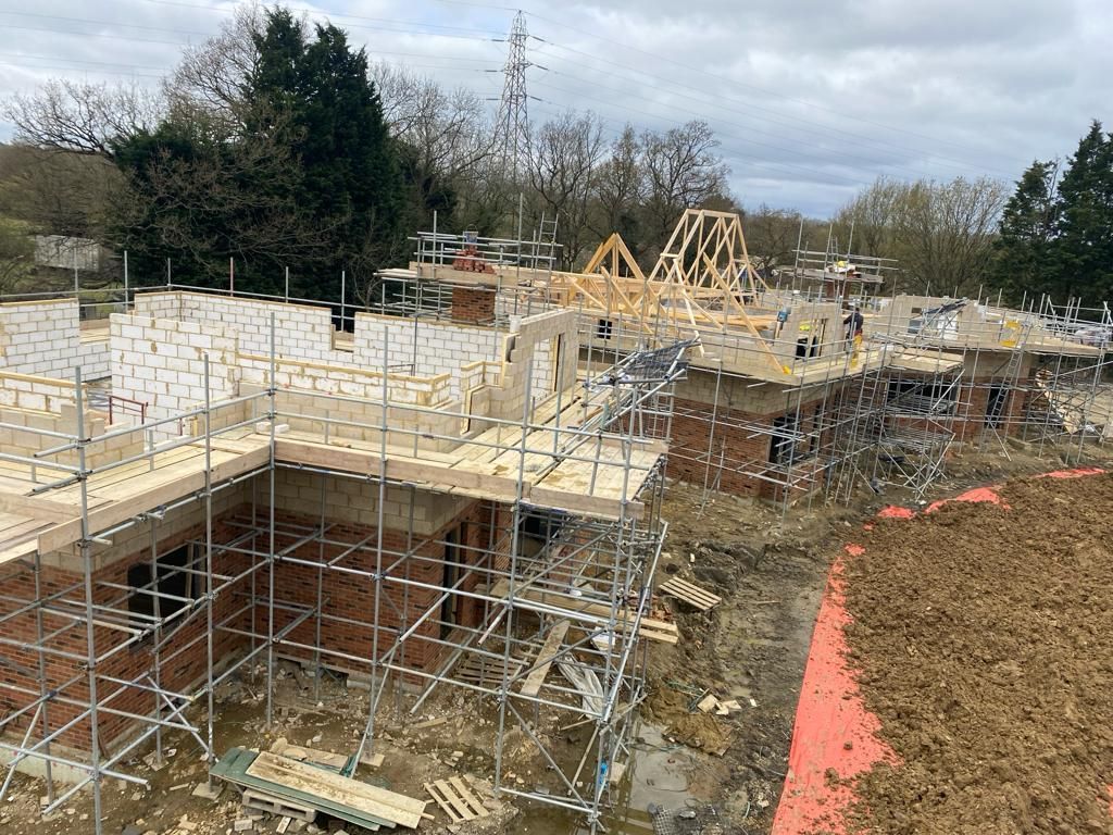 A large building under construction with scaffolding and a roof.
