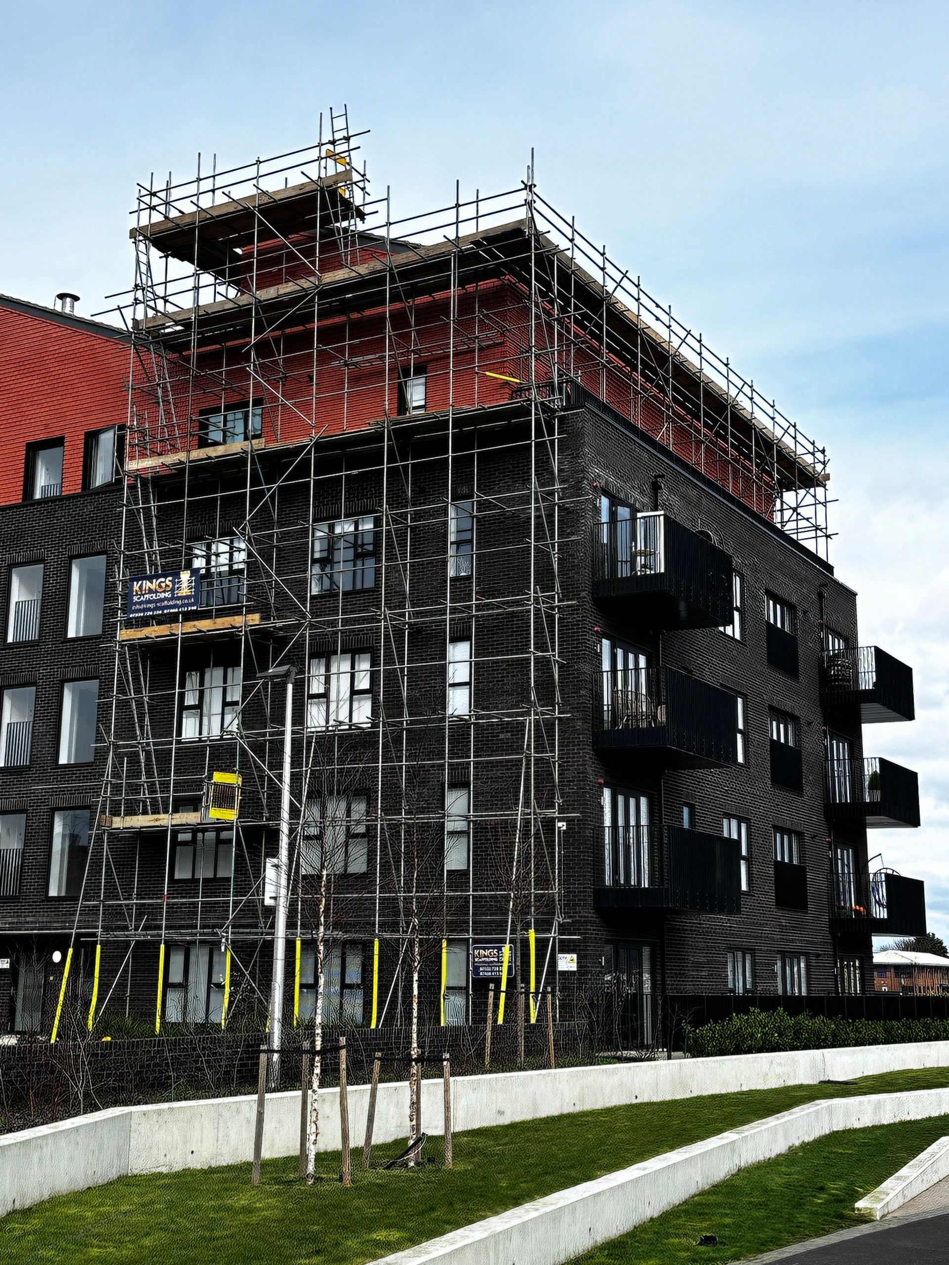 A large building under construction with scaffolding on the side of it.
