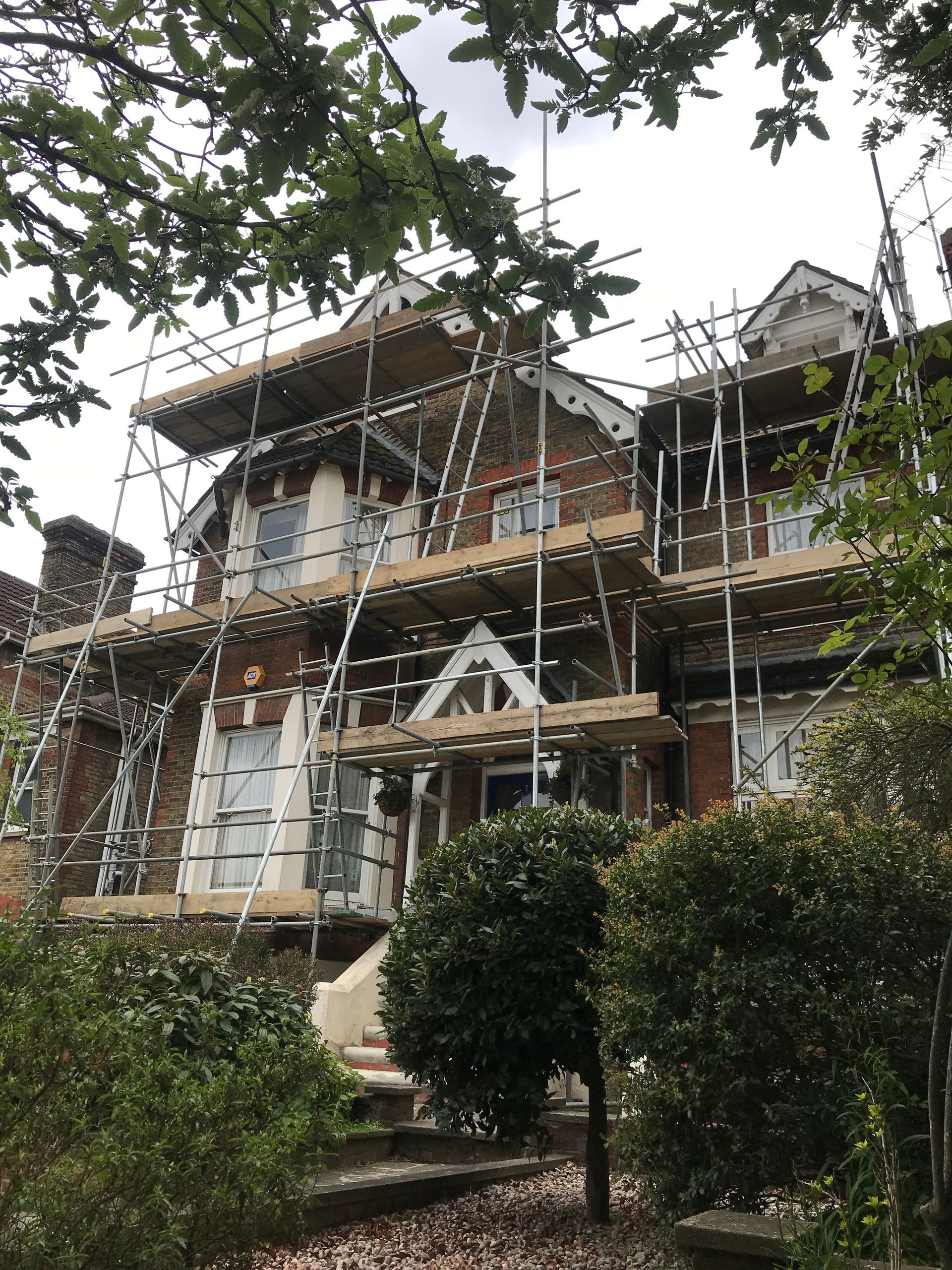 A large house with scaffolding on the side of it.