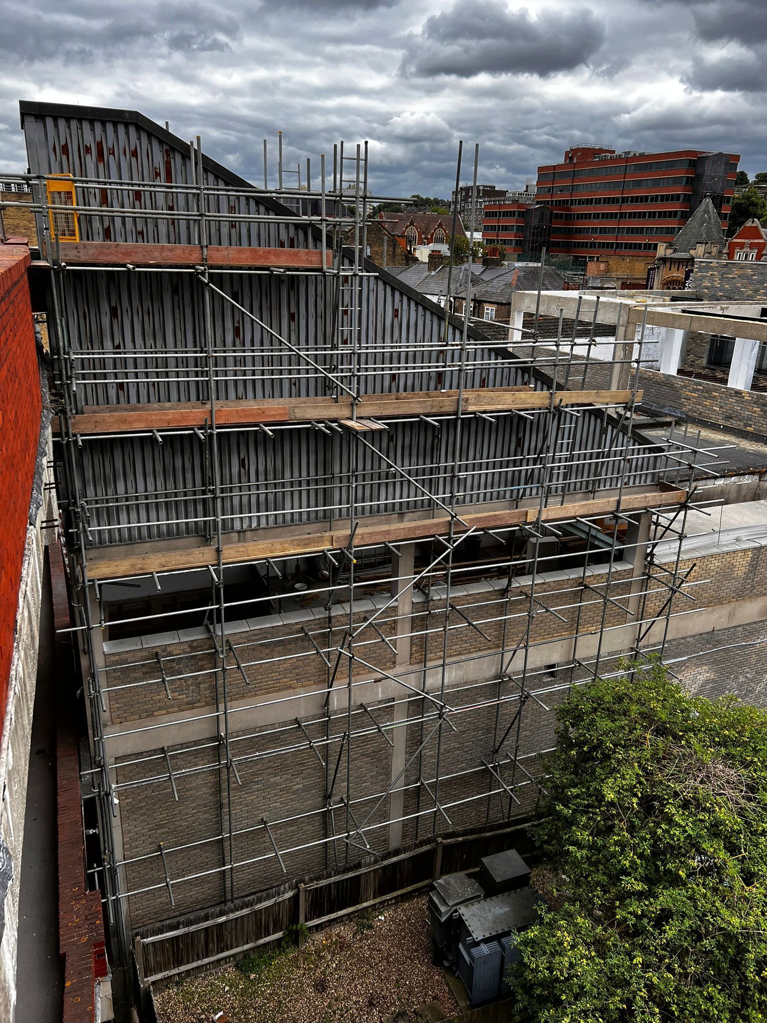 An aerial view of a building under construction with scaffolding.