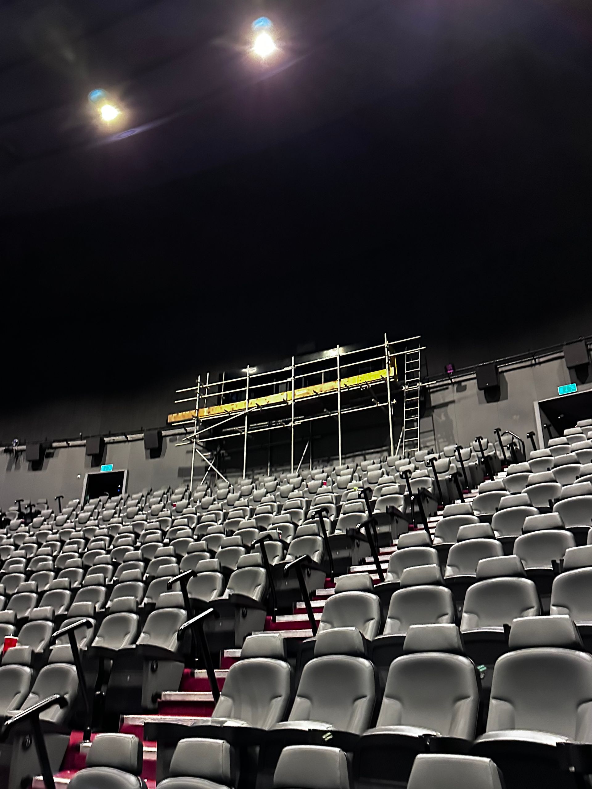 A large auditorium filled with rows of empty seats