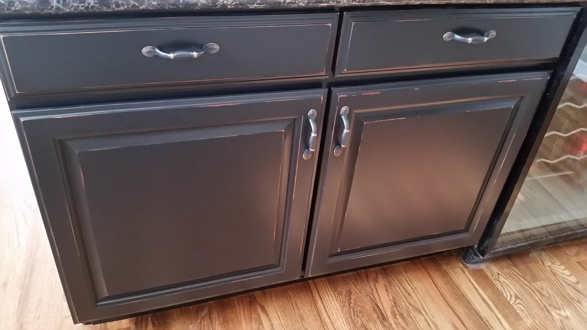 distressed gray finish on kitchen cabinet