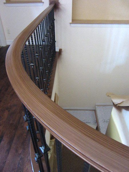 close up of faux wood finish on top of stair rail.