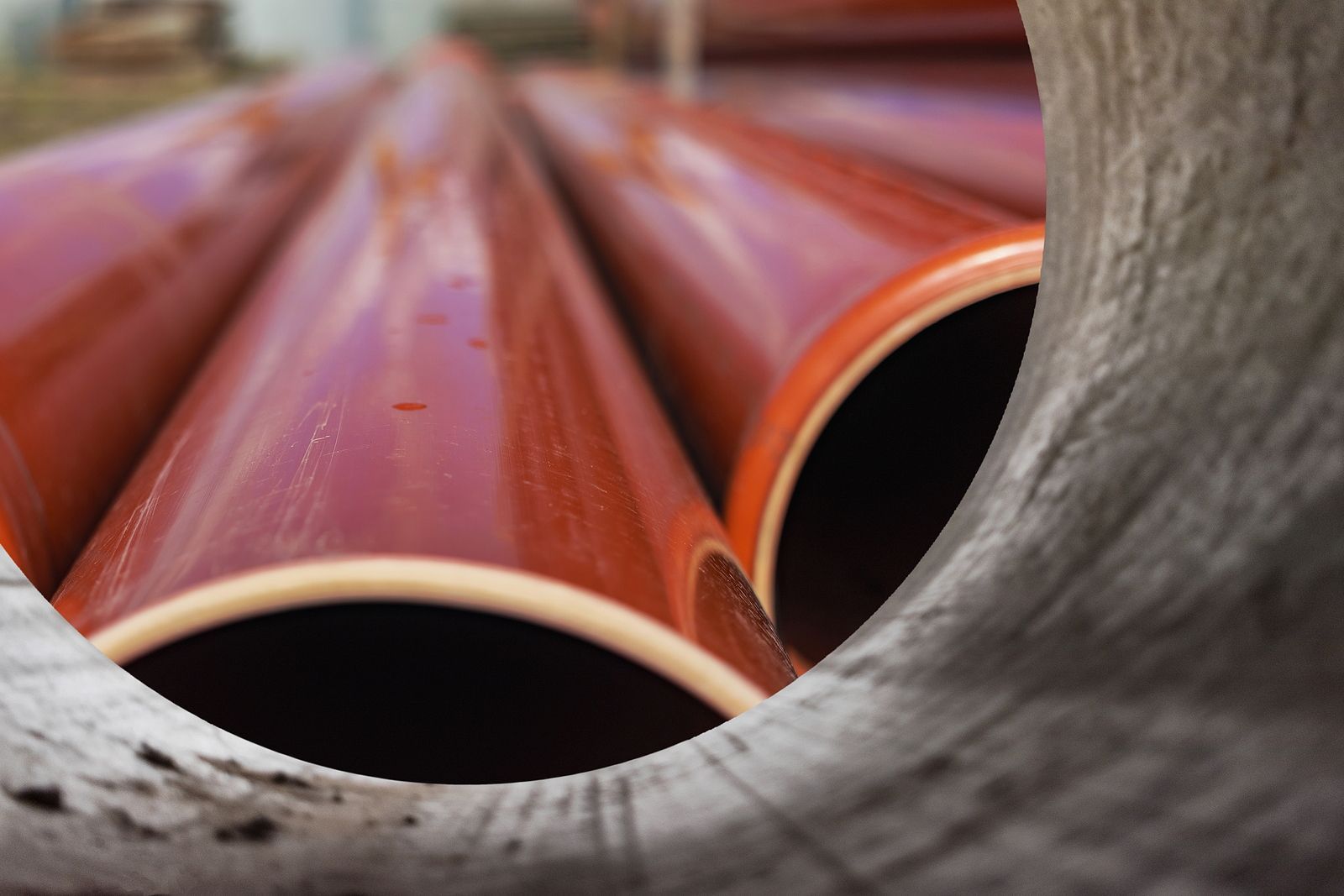 A bunch of red pipes are stacked on top of each other