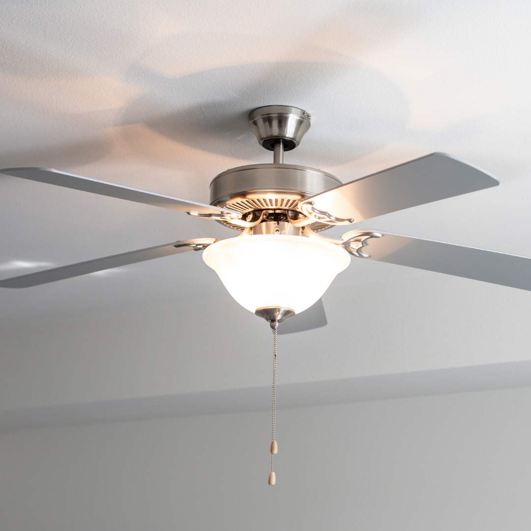 A ceiling fan with a light attached to it is hanging from the ceiling.