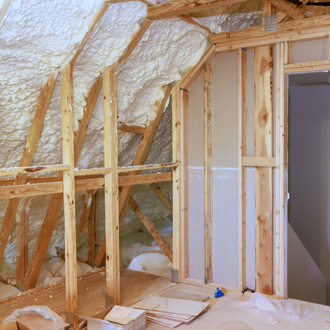 A room with wooden beams and foam insulation on the ceiling.