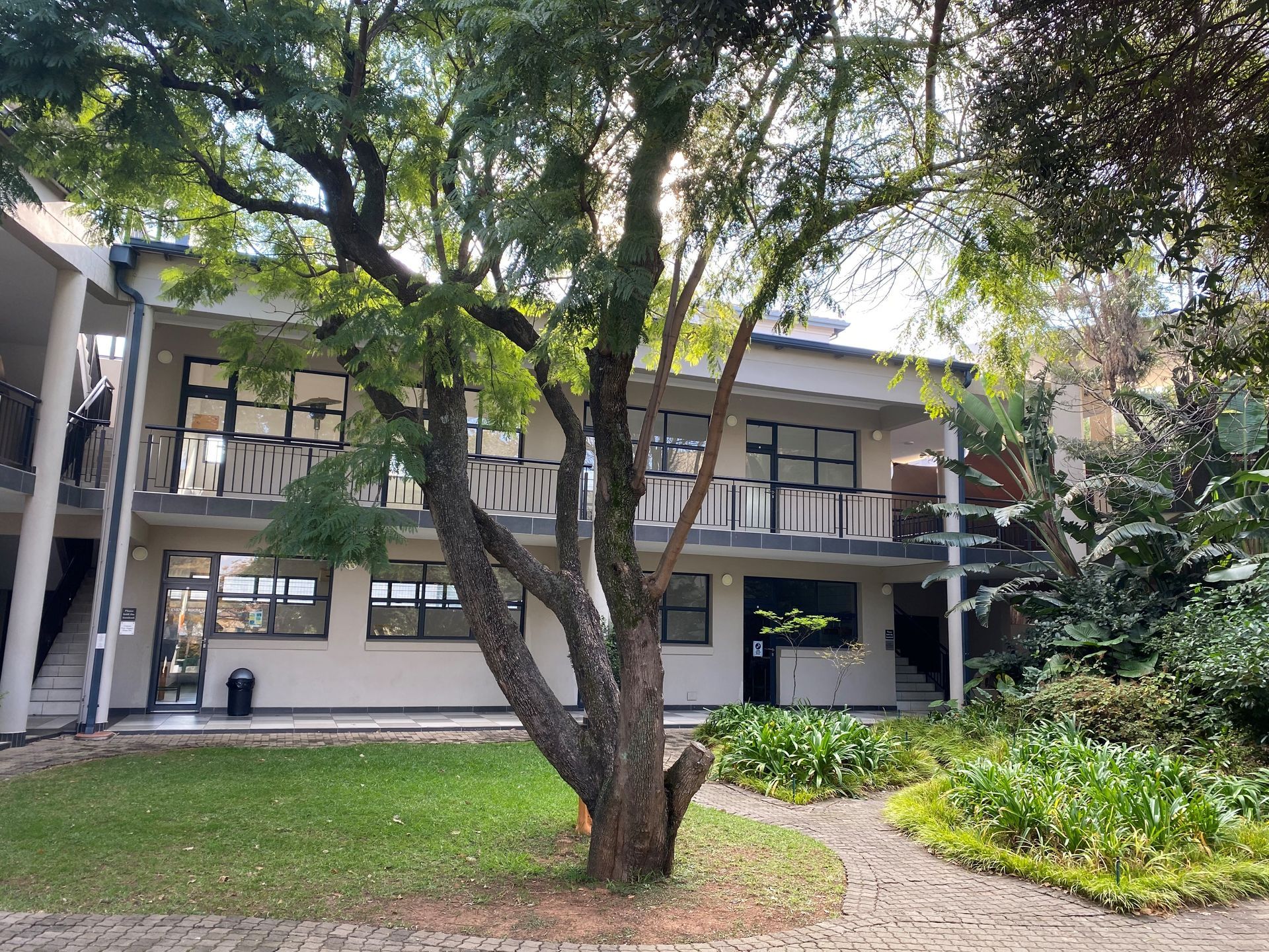 A large building with a tree in front of it.
