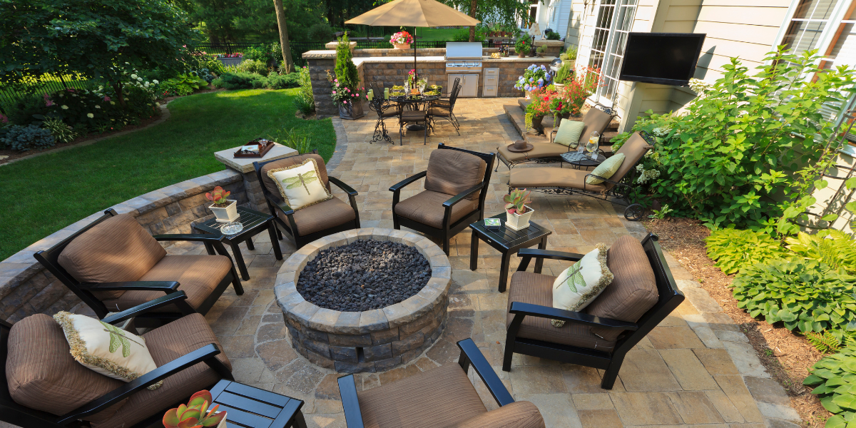 A beautifully decorated garden with elegant furniture is set up for an outdoor party.