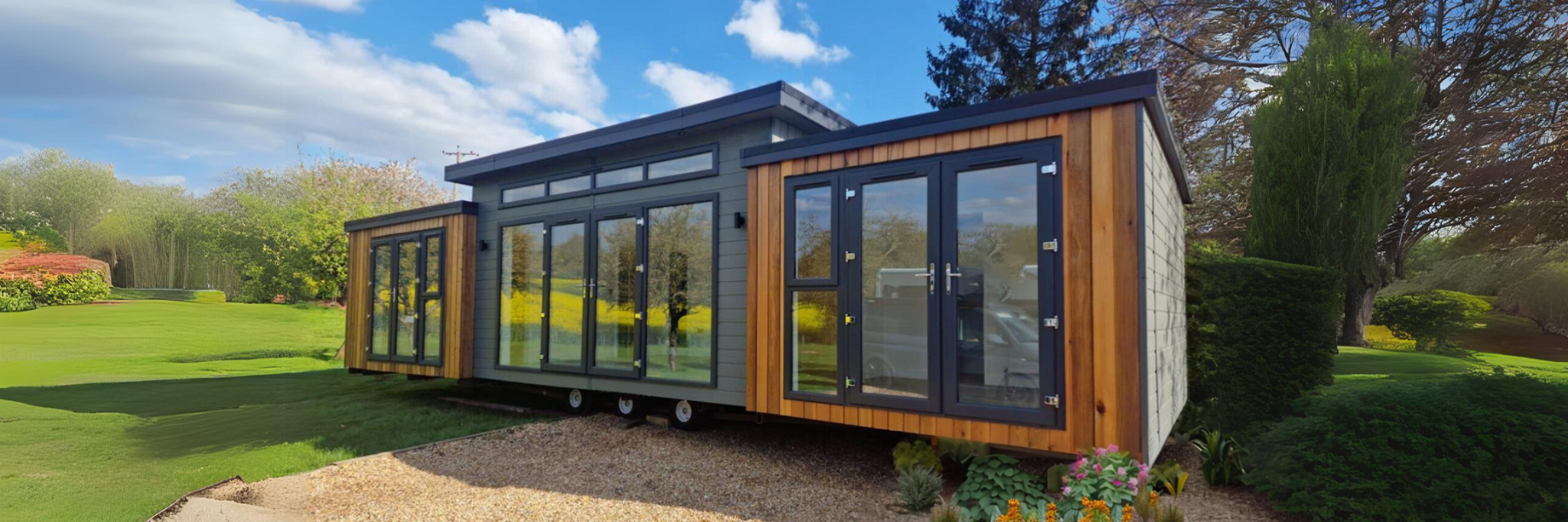 A contemporary modular garden room with expansive glass panels, cedar cladding.