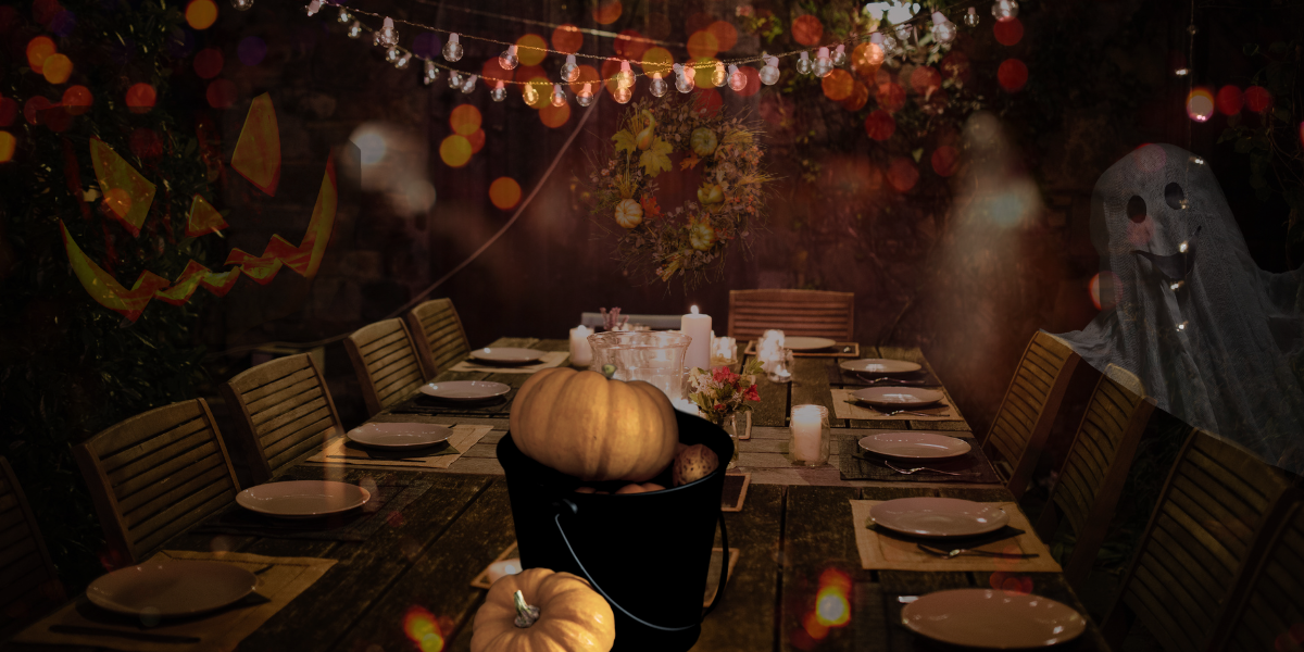 A garden beautifully designed for Halloween, with lighting, pumpkins, and zones for entertaining.