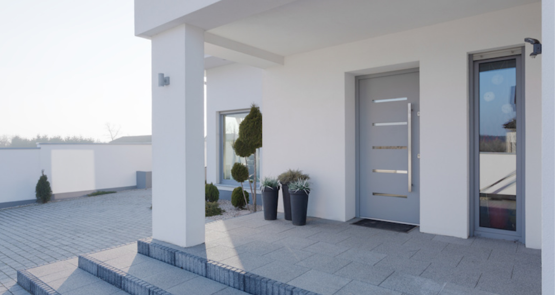 A stunning luxury entrance door framed by elegant stonework showcasing a superior crafted door.