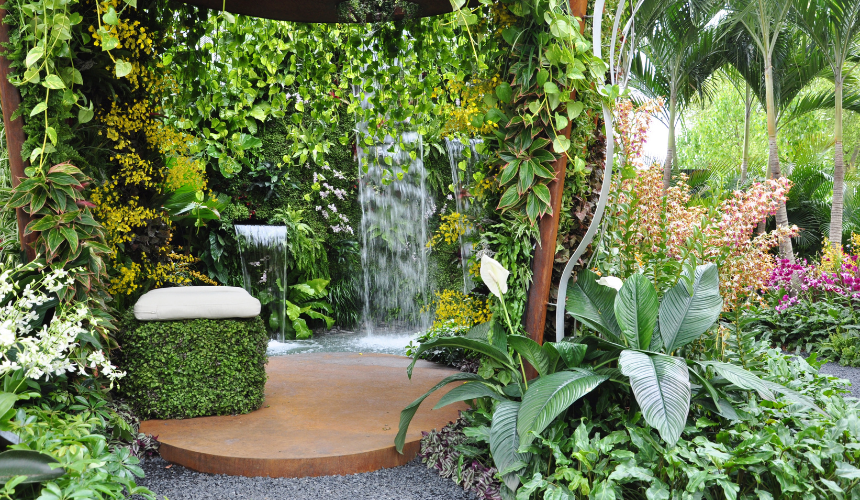 A creative masterpiece: hidden cascading waterfalls emerge from lush plantings, blending seamlessly into stone walls and a cosy seating area, offering an immersive and tranquil connection to nature.