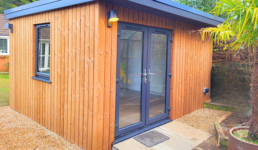 A luxury small garden cabin with cedarwood cladding, triple-glazed windows and doors, eco-friendly drainage, and premium finishes inside and out by Greenway.