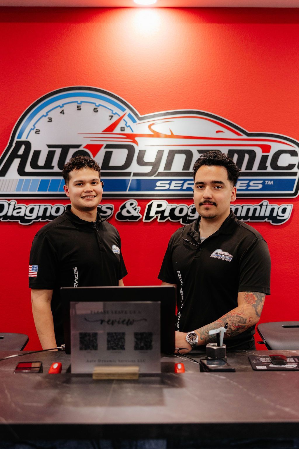 Mechanics Standing In Front of Desk | Auto Dynamic Services LLC