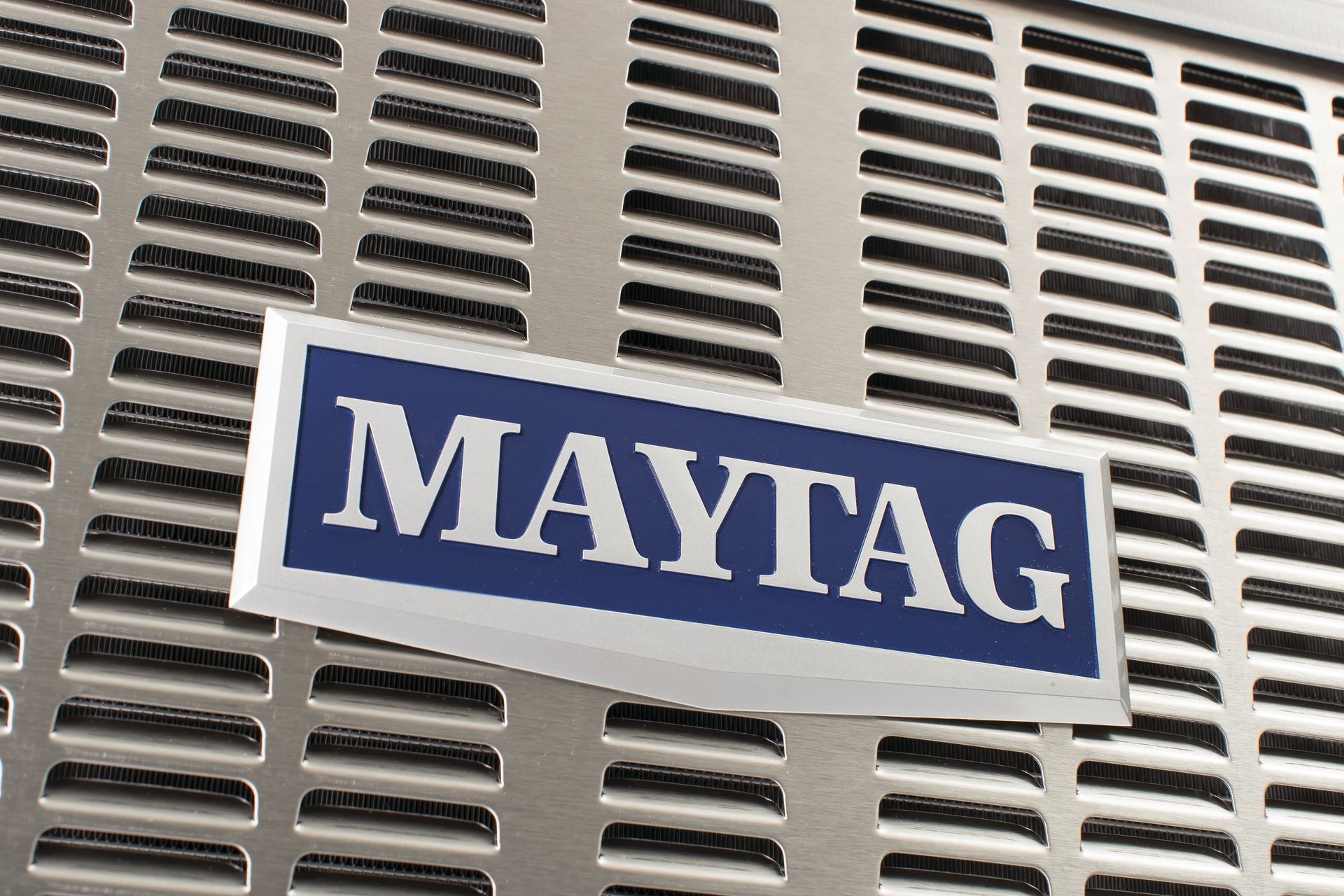 A maytag sign is on a metal grille