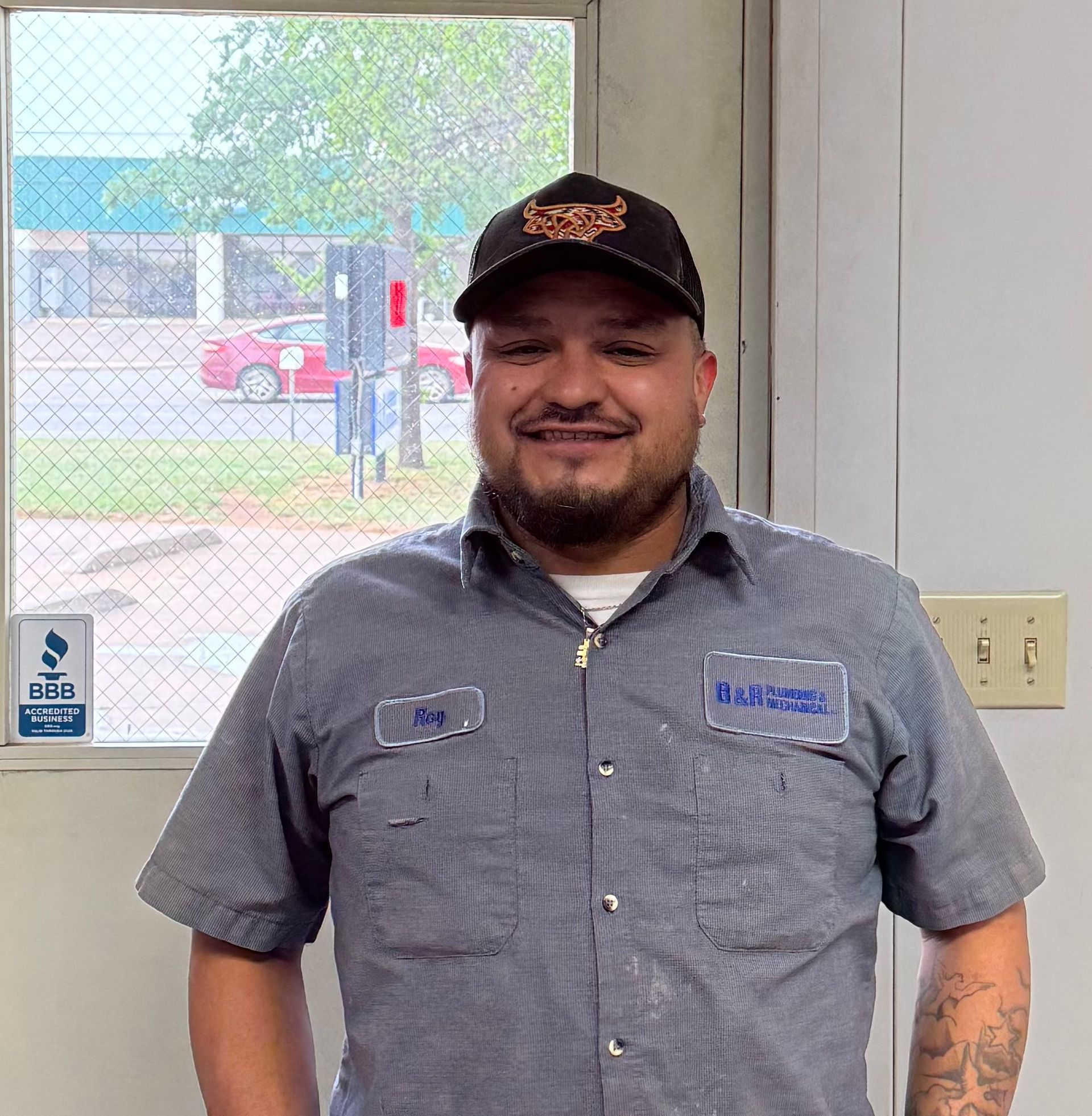 A man wearing a hat and a name tag that says ' shawn ' on it