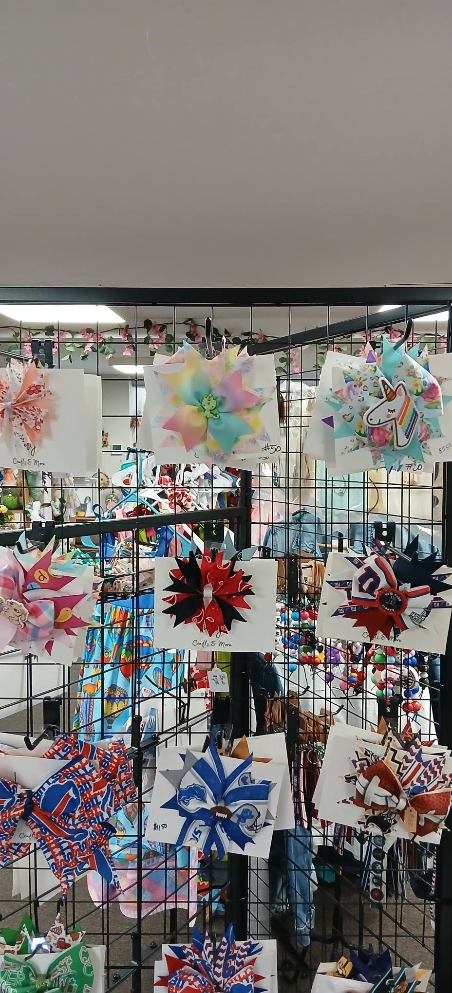 Colorful paper pinwheels and decorations displayed on a rack at a market stall