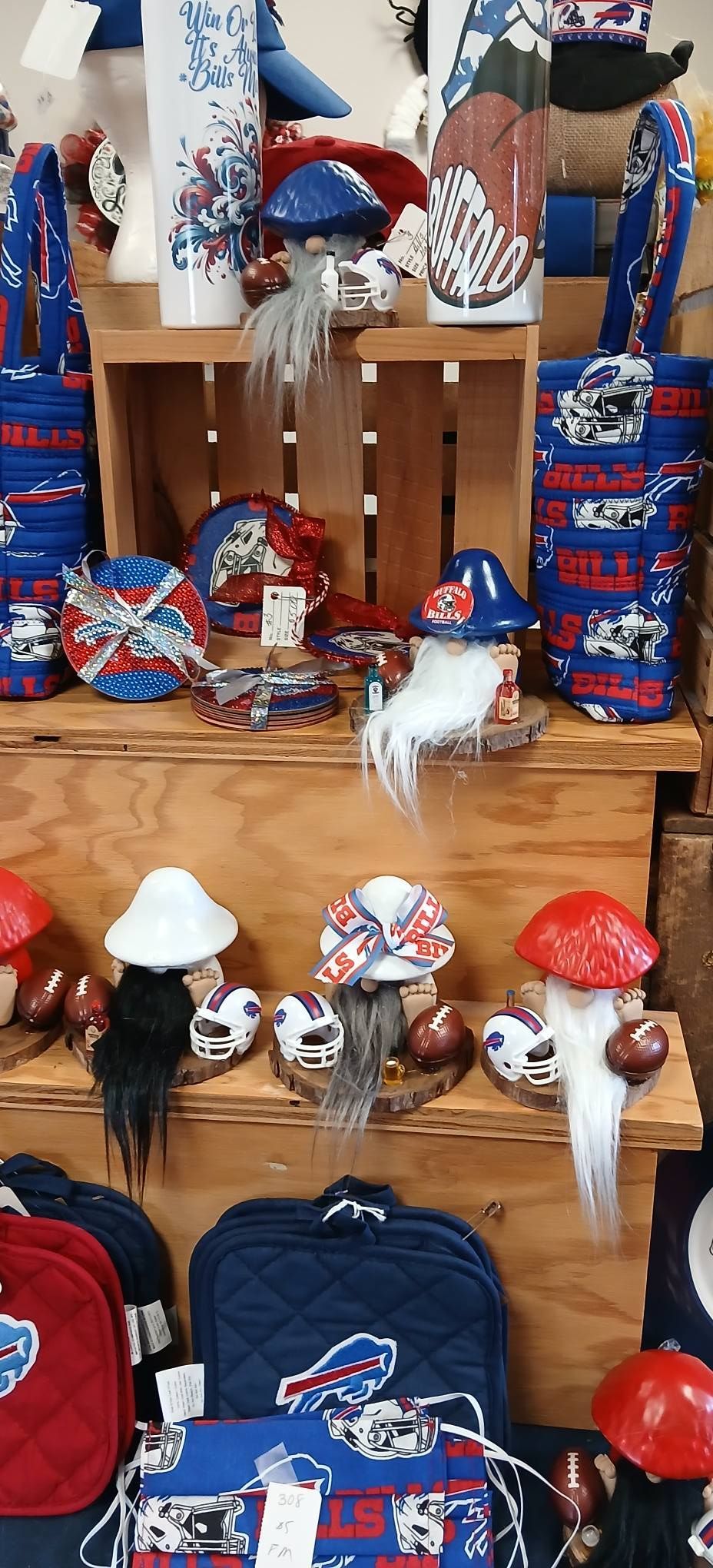 Assorted red, white, and blue baseball-themed souvenirs displayed on wooden shelves in a shop.