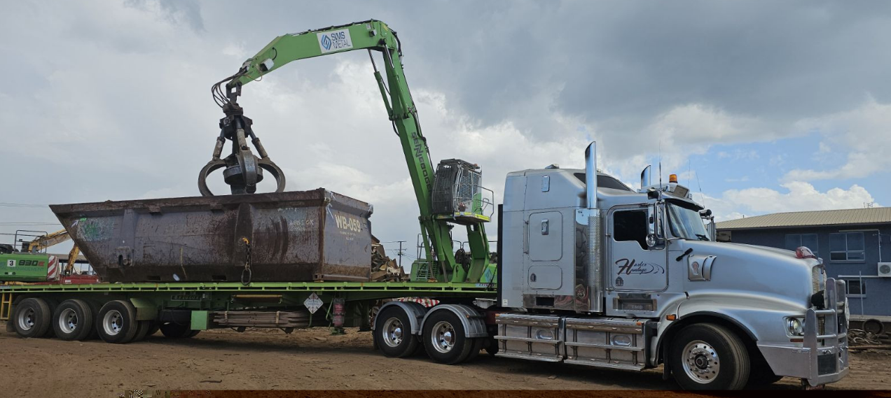 A Semi Truck With a Crane Attached to It is Carrying a Dumpster — Harker Haulage In Humpty Doo, NT