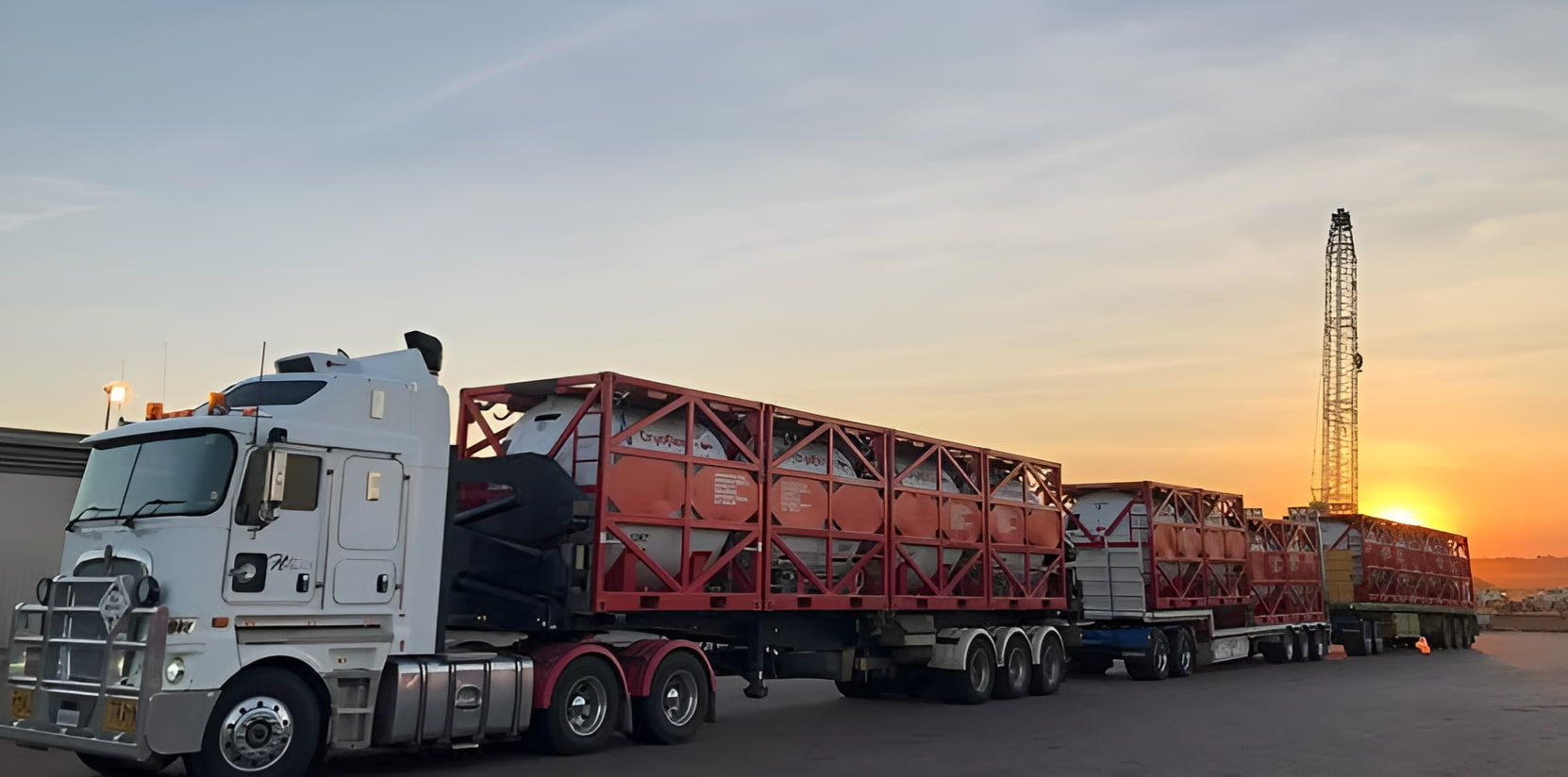 A large semi truck is parked in a parking lot at sunset — Harker Haulage In Howard Springs, NT A large semi truck is parked in a parking lot at sunset — Harker Haulage In Howard Springs, NT