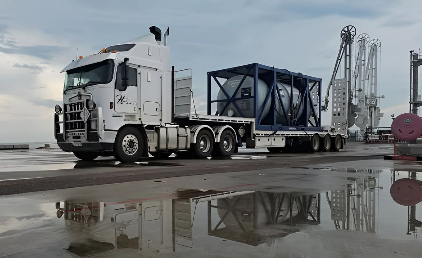 A Large White Semi Truck is Parked in a Puddle of Water — Harker Haulage In East Arm, NT